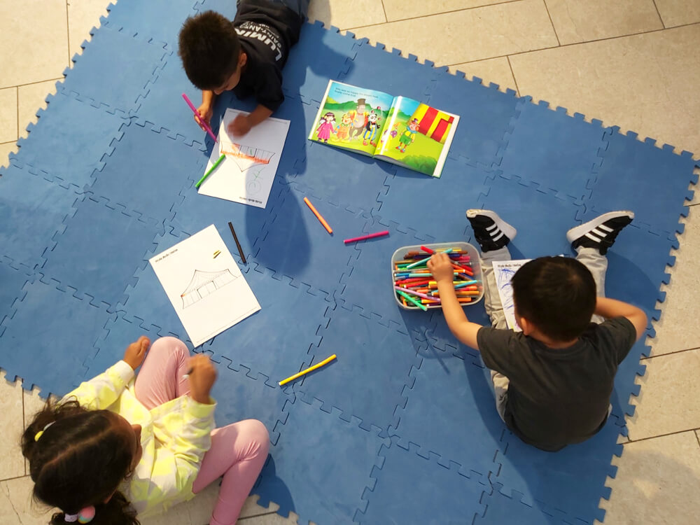 Children drawing with picture book, Billy Joins the Circus, at The O2 image