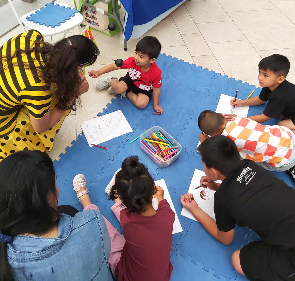 Anna Christina drawing with the children at The O2 image